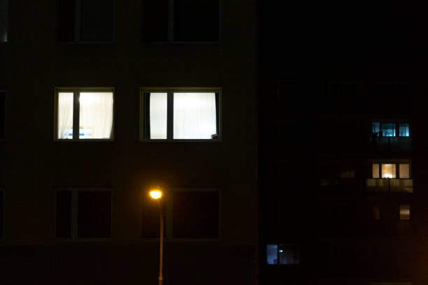 istock A tall building with numerous windows that are illuminated at night 2204595054