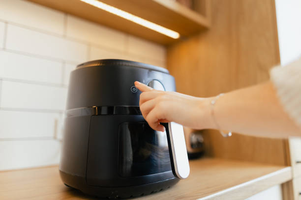 istock Close-Up of Woman Setting Program in Air Fryer 2204596866