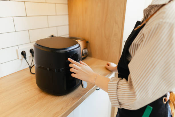 istock Close-Up of Woman Setting Program in Air Fryer 2204596882