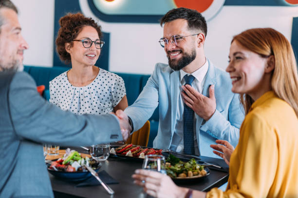 istock Businesspeople shaking hands at the restaurant. 2204599572
