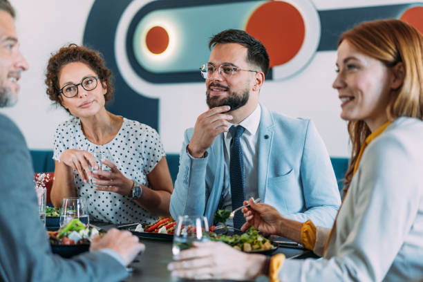 istock Businesspeople having lunch together. 2204599583