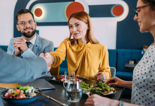 istock Businesspeople shaking hands at the restaurant. 2204599587