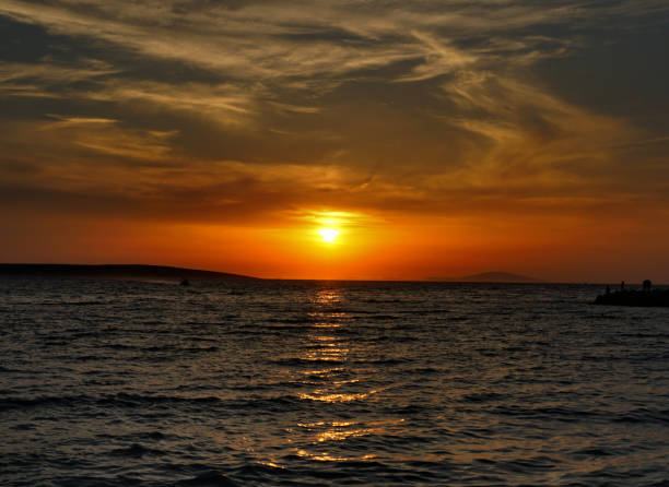 istock Dramatic summer sky during vivid orange sundown at the seaside 2204603593