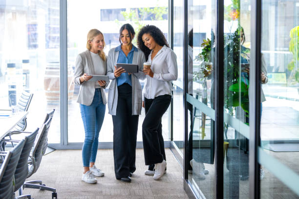 istock Three business women working looking at digital tablets. 2204603896