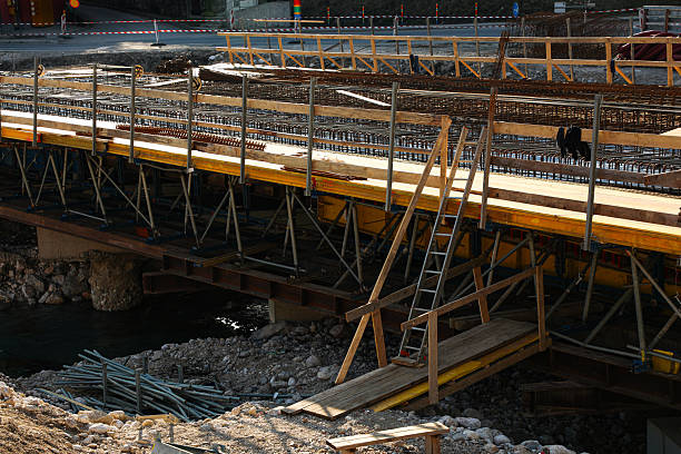 istock Work is underway by a construction contractor to build a motor vehicle bridge across a mountain river (part of the series 