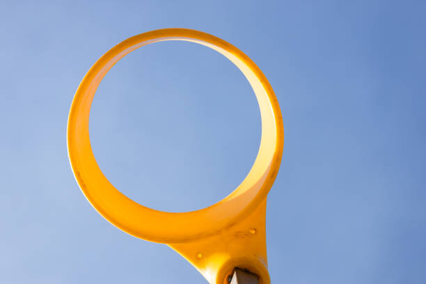 This image features a bright yellow circular frame that stands out sharply against a clear blue sky, creating an aesthetically pleasing visual appeal focusing on vibrant colors.