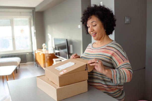 istock Woman receiving packages inside a modern home interior setting 2204611666