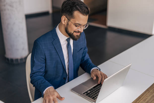 istock Businessman working on laptop in modern office 2204612276