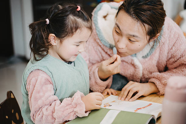 istock A Chinese woman and her daughter are doing homework 2204613083