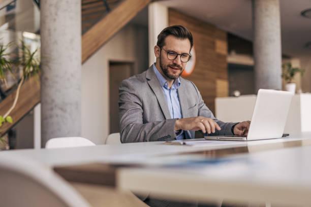 istock Businessman working on laptop in modern office 2204613223