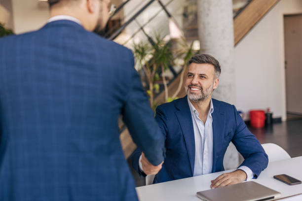 istock Two businessmen shaking hands after a successful meeting 2204615120