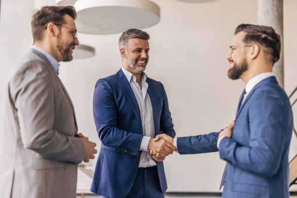 istock Businessmen shaking hands after successful meeting in office 2204615691