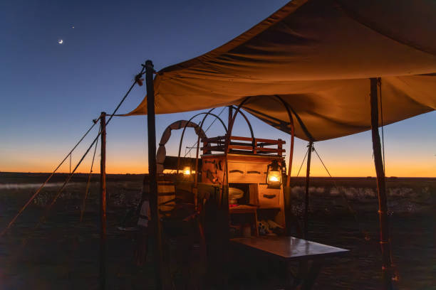 istock Kerosene lanterns hanging on an old chuck wagon. 2204615998