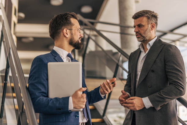 istock Two businessmen talking and discussing a project in a modern office 2204616230