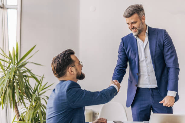 istock Two businessmen shaking hands after a successful meeting 2204616687