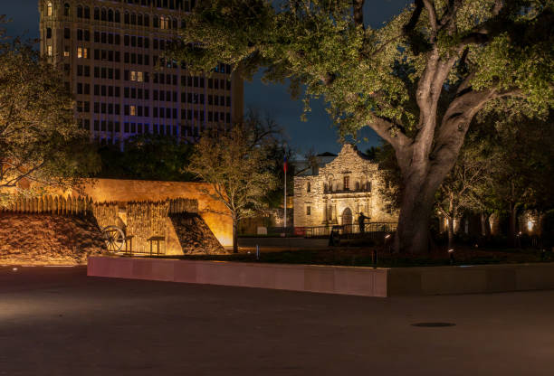 Illuminated Alamo Mission in San Antonio glows in the dark before sunrise revealing its iconic facade and historical charm.