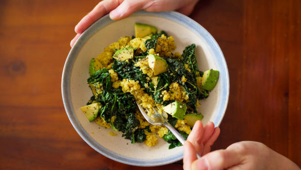 istock eating vegan quinoa, kale, and avocado salad 2204620006