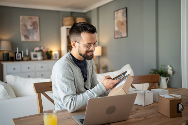 istock Small business owner preparing packages for shipment at home 2204621914