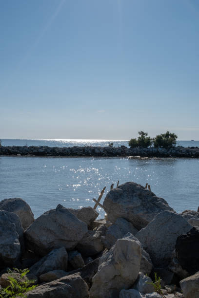 istock Rocky coastline with sparkling sea 2204623797