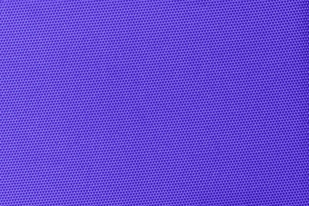 A vibrant purple fabric with a tight honeycomb pattern, creating a modern and clean texture. Ideal for use in fashion, interior design, or as a versatile background element. Violet gradient