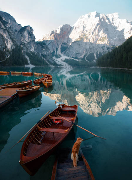 istock Wooden boats on clear lake 2204624634
