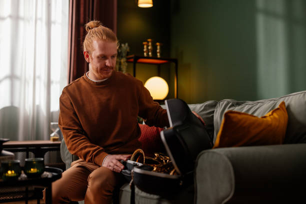 Musician unpacking his saxophone at home
