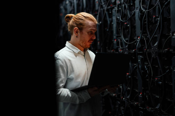istock It specialist working with laptop in server room 2204625552