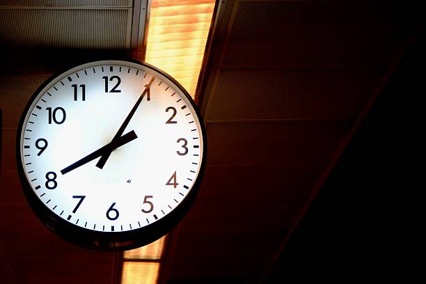 istock Passenger handles in a subway. Clock at the station close-up view 2204627224