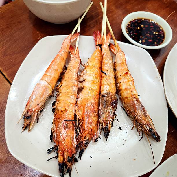 istock Vietnamese charcoal-grilled shrimp skewers on a plate 2204630881