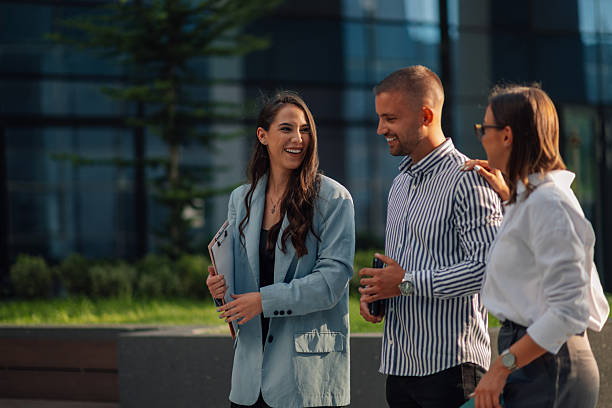 istock Business people having conversation walking outdoors together 2204634499
