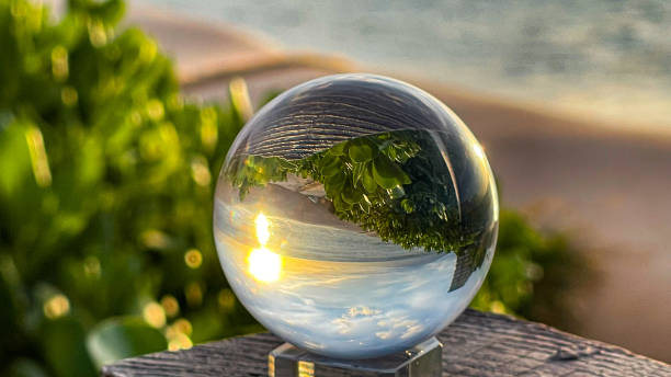 A crystal ball reflects the ocean and beach of Maui Hawaii