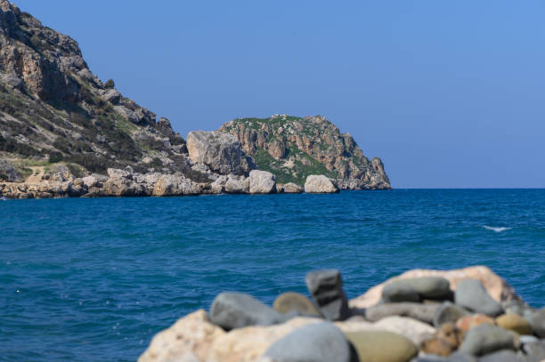 istock Serene coastal view with rocky formations under a clear blue sky 2204635605