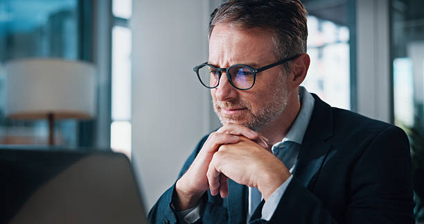 istock Business, thinking and man in office, laptop and internet with problem solving, network and decision. Person, employee and accountant in workplace, computer and connection with choice and planning 2204636217