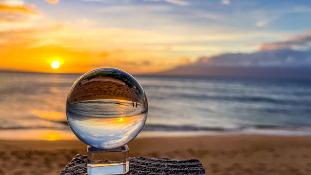 A crystal ball reflects the ocean and beach of Maui Hawaii