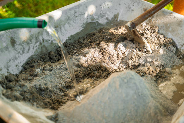 istock Mixing Cement in a Wheelbarrow 2204639181