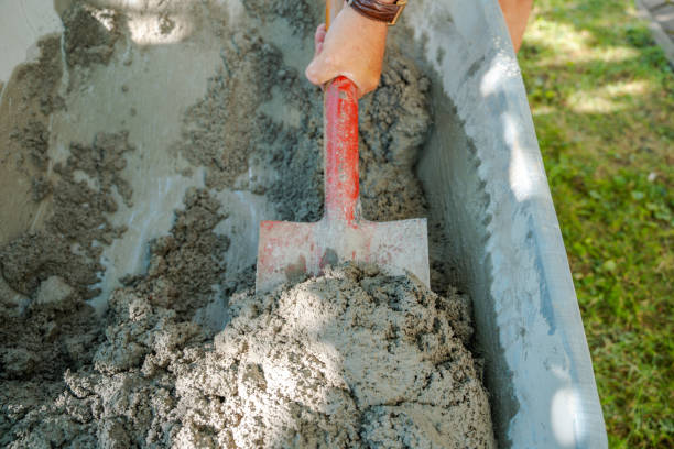 istock Mixing Concrete in a Wheelbarrow 2204639183