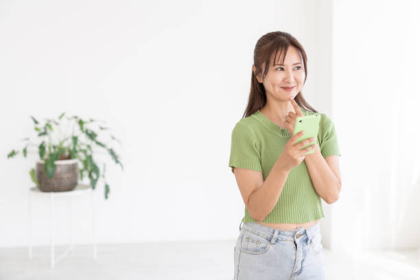 istock attractive Asian woman using a smart phone 2204639871