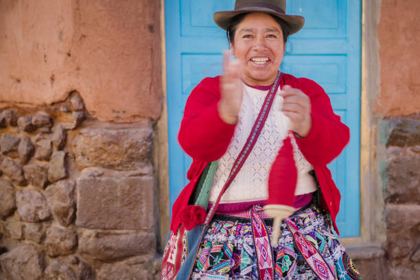 istock Peruvian woman spinning a wool in Pisac, Urubamba Valley 2204646290
