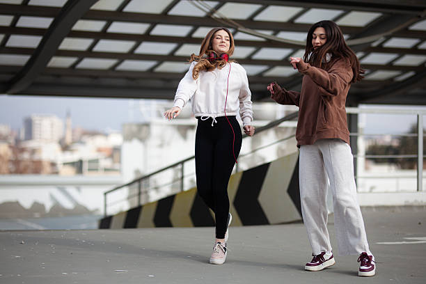 istock Two Young Women Enjoying a Fun Outdoor Dance Activity Together 2204647792