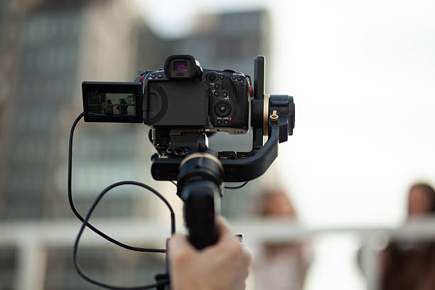 istock Professional video camera mounted on a stabilizer capturing outdoor scenes. 2204647810