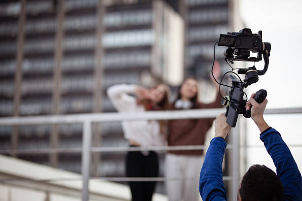 istock Capturing a moment on a rooftop setting with a professional video camera 2204647815