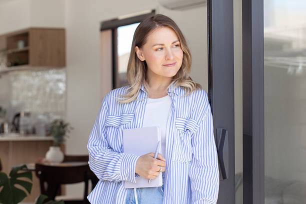 istock Determined blonde woman hold notebook and pen in office 2204650731