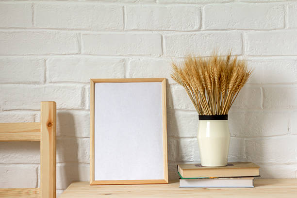 Mockup of four horizontal frames on a wall and interior decoration with plant and objects on a table. 3D rendering, interior design, 3D illustration