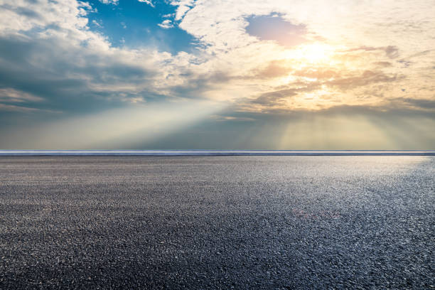 istock Asphalt road and dramatic sky with sun rays natural background 2204653834