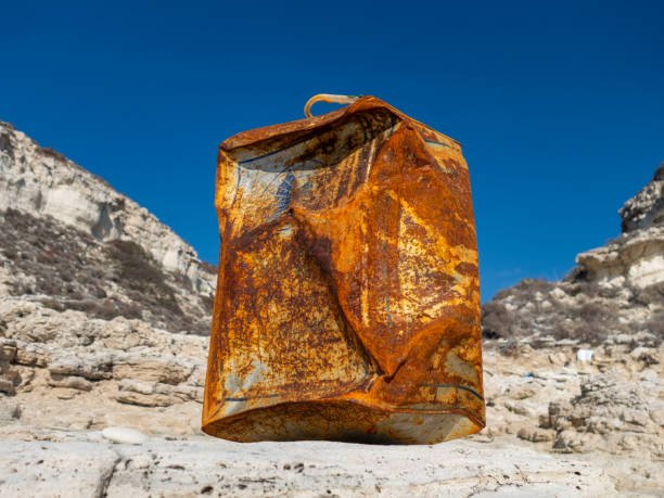 A rusty oil can that has been on the beach for a long time