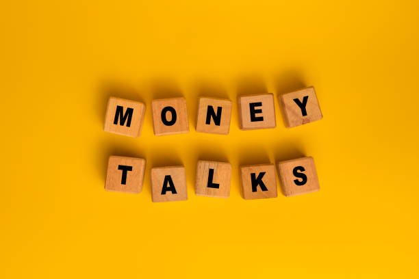 istock money talks words on wooden blocks isolated on orange background 2204657803