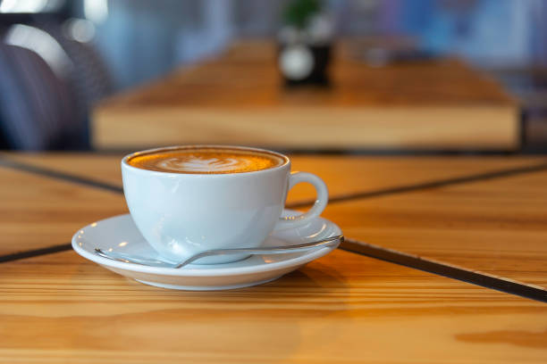 istock coffee latte art on wood table in cafe nature light 2204662034