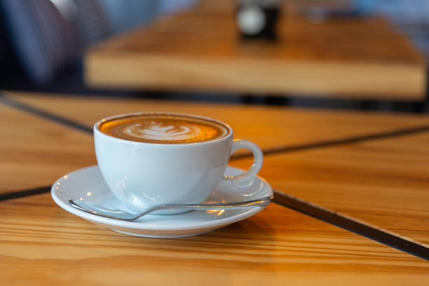 istock coffee latte art on wood table in cafe nature light 2204662056