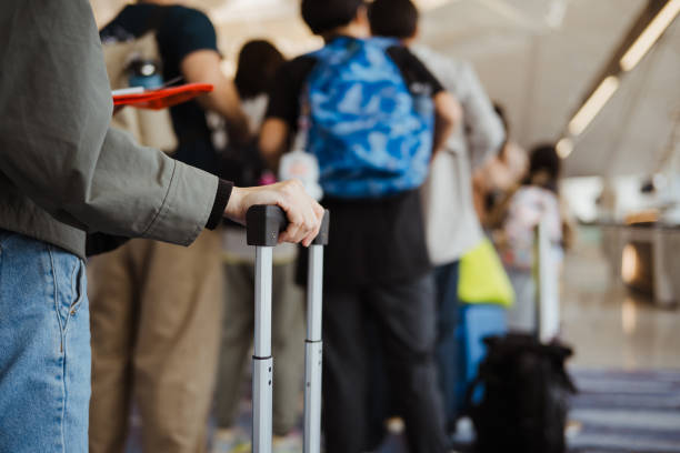 istock Ready For Travelling: An Unrecognizable Asian Holding Her Passport And Other Documents 2204662161