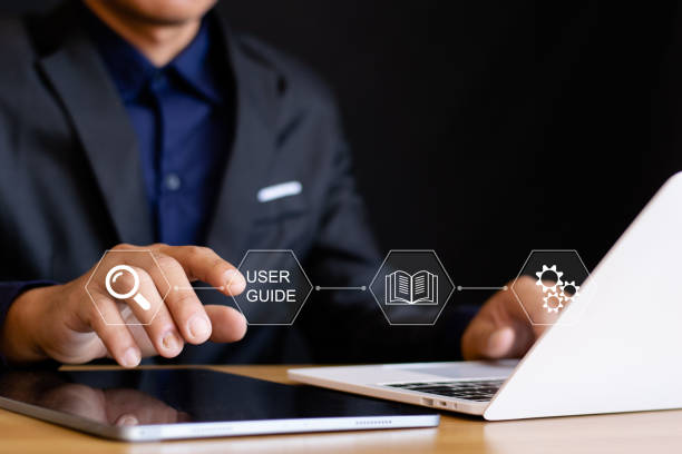 istock Businessman using laptop with virtual user manual icon for business services, online manuals and strategy guides. 2204662255